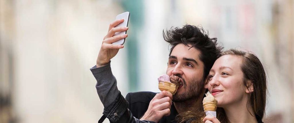 Two people looking at their smartphone